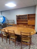 An eight piece 20th century teak G-Plan dining room suite comprising display unit fitted cupboards