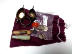 A cloth bag containing silver napkin ring and pair of silver twin handled salts,