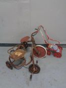 Two mid 20th century child's tin plate tricycles, one with sprung seat,