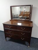 A late Victorian four drawer dressing table raised on shepherd's castors