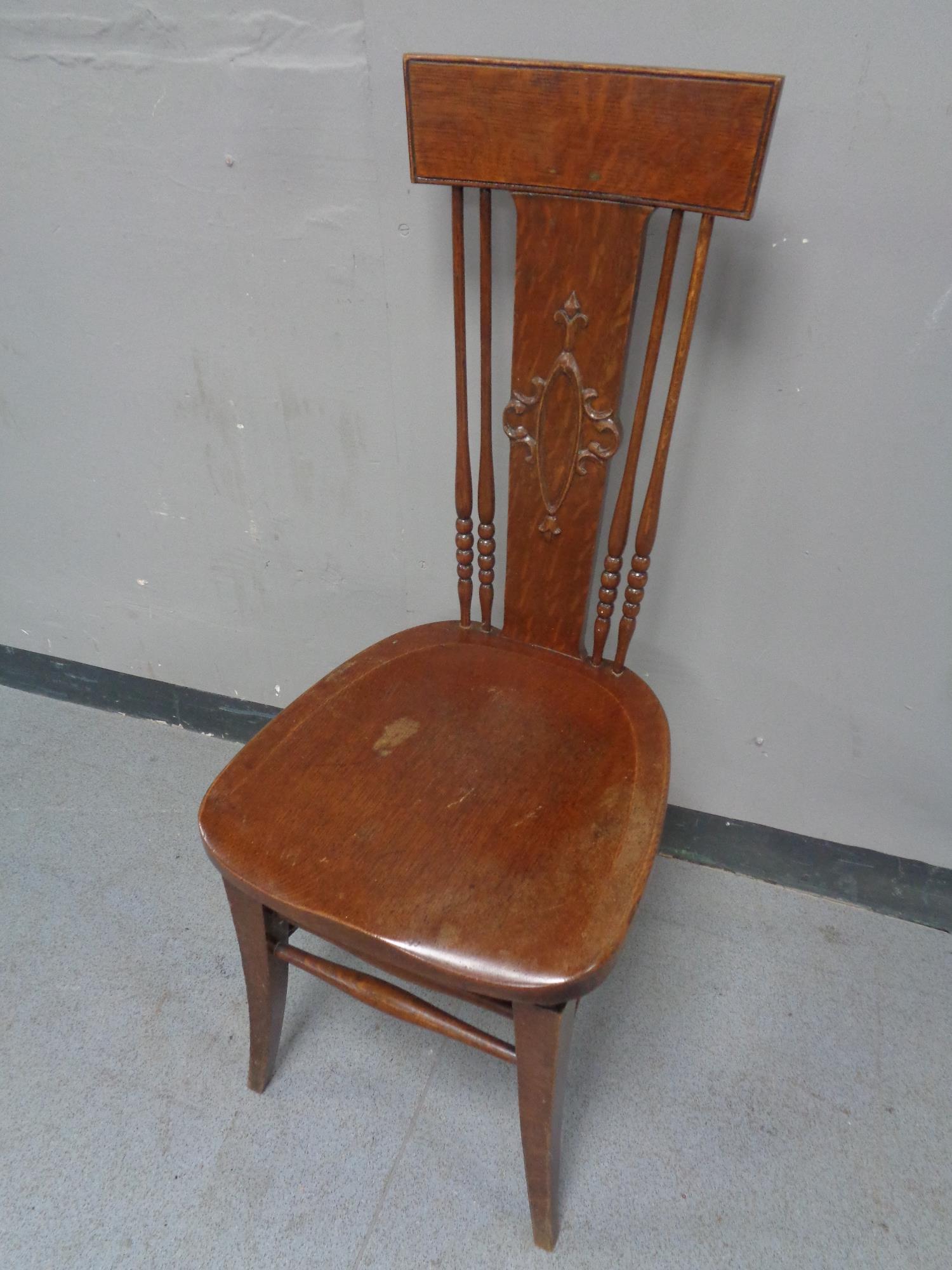 An Edwardian high backed beech hall chair