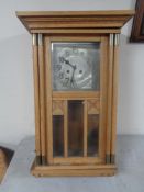 A early 20th century continental oak cased eight day wall clock with silver dial