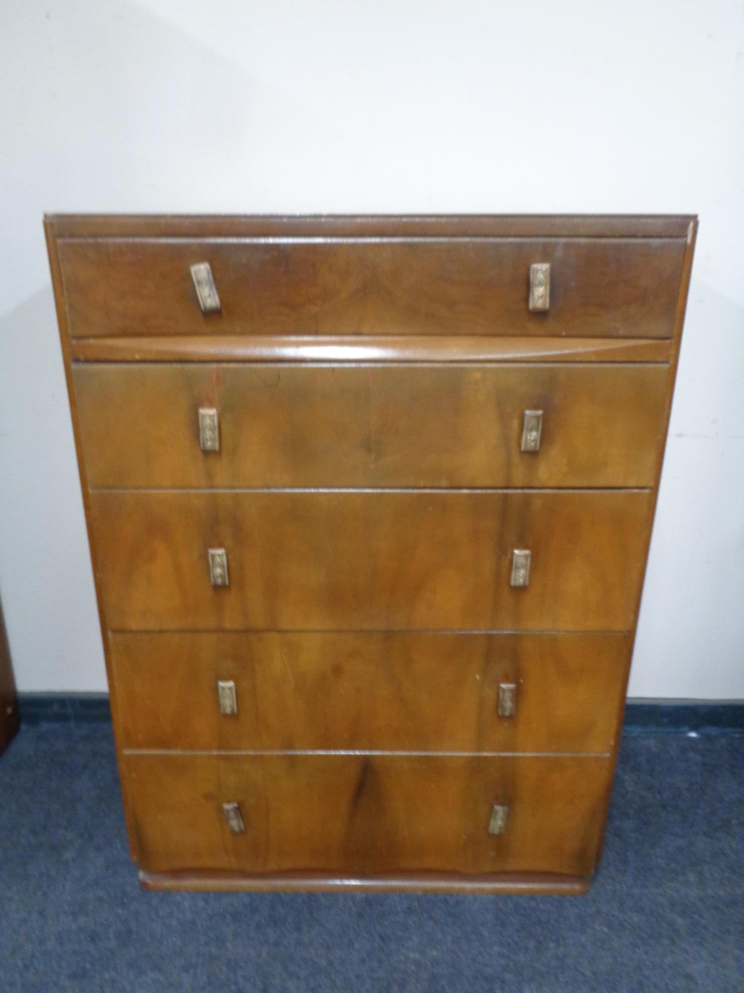 A mid 20th century walnut five drawer chest