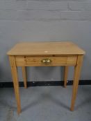 An antique pine side table fitted a drawer