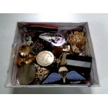 A box containing assorted military badges,