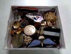 A box containing assorted military badges,