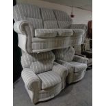 A three piece lounge suite upholstered in a grey striped fabric