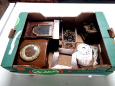 A box containing clock cases and parts,