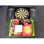 A Winmau diamond dartboard in cabinet together with a further box containing games,