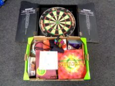 A Winmau diamond dartboard in cabinet together with a further box containing games,