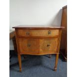 An inlaid mahogany double door cabinet fitted a drawer above on raised legs