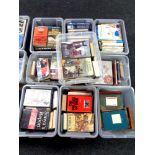 A pallet containing nine plastic lidded storage crates containing books,