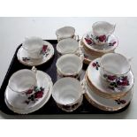 A tray containing 12 English bone china rose patterned trios