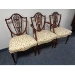 A set of eight reproduction mahogany Hepplewhite dining chairs comprising of two carvers and six
