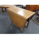 An Edwardian oak gate leg table