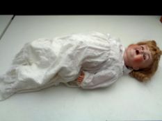 A 20th century porcelain headed doll