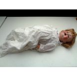 A 20th century porcelain headed doll