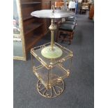 A 20th century brass and glass revolving two tier occasional table together with a further gilt and