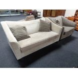 A contemporary two seater settee and armchair upholstered in beige and striped fabric with three