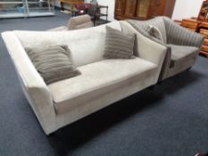 A contemporary two seater settee and armchair upholstered in beige and striped fabric with three