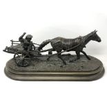 An antique bronze figure of a girl riding on a cart with horse, indistinctly signed Anna **,