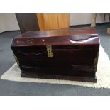 An eastern hardwood dome top trunk with brass mounts and handles,