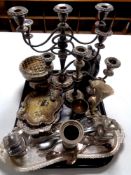 A tray containing 20th century plated wares to include rose bowl, table candelabra, trays, cruets,