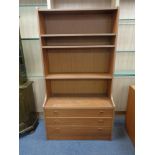 A set of mid 20th century teak effect open bookshelves fitted three drawers beneath