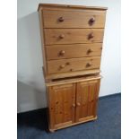 A pine four drawer chest together with pine double door cupboard