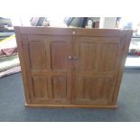 An antique pine double door school cupboard retailed by The Educational Supply Associates of London