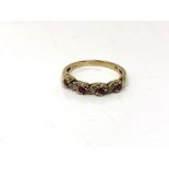 A 9ct gold ruby and diamond half eternity ring, size O. CONDITION REPORT: 2.