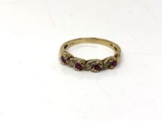 A 9ct gold ruby and diamond half eternity ring, size O. CONDITION REPORT: 2.