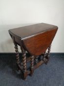 An Edwardian oak barley twist gate leg table