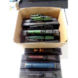 A box containing 15 die cast model trains on stands to include Flying Scotsman, A4 Mallard,