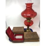 A tray of brass oil lamp with cranberry glass shade, cased Selangor pewter hip flask,
