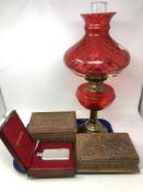 A tray of brass oil lamp with cranberry glass shade, cased Selangor pewter hip flask,