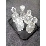A tray containing five cut glass lead crystal decanters.