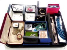 A tray containing boxed costume jewellery to include beaded necklaces, Celtic brooches,