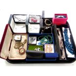 A tray containing boxed costume jewellery to include beaded necklaces, Celtic brooches,