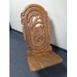 A heavily carved African fertility chair carved with a rhino