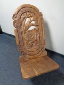 A heavily carved African fertility chair carved with a rhino