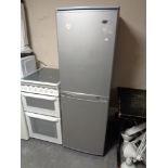 An upright fridge freezer (silver)