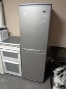 An upright fridge freezer (silver)