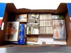 A box containing a quantity of cigarette and tea card albums and cards