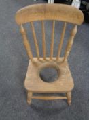 An antique pine child's commode chair