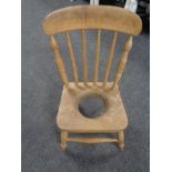 An antique pine child's commode chair