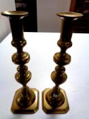 A pair of antique brass candlesticks