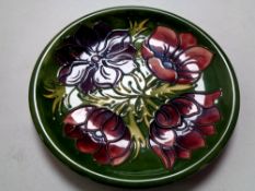 A William Moorcroft Anemone plate on green ground, width 25.