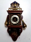 A continental wall clock with brass pear drop weights