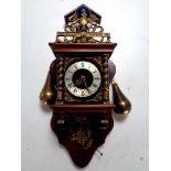 A continental wall clock with brass pear drop weights